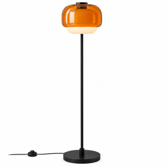 A modern floor lamp with a rounded amber glass shade, a slim black metal stem, and a round black base on a white background.